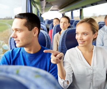 happy couple or passengers in travel bus